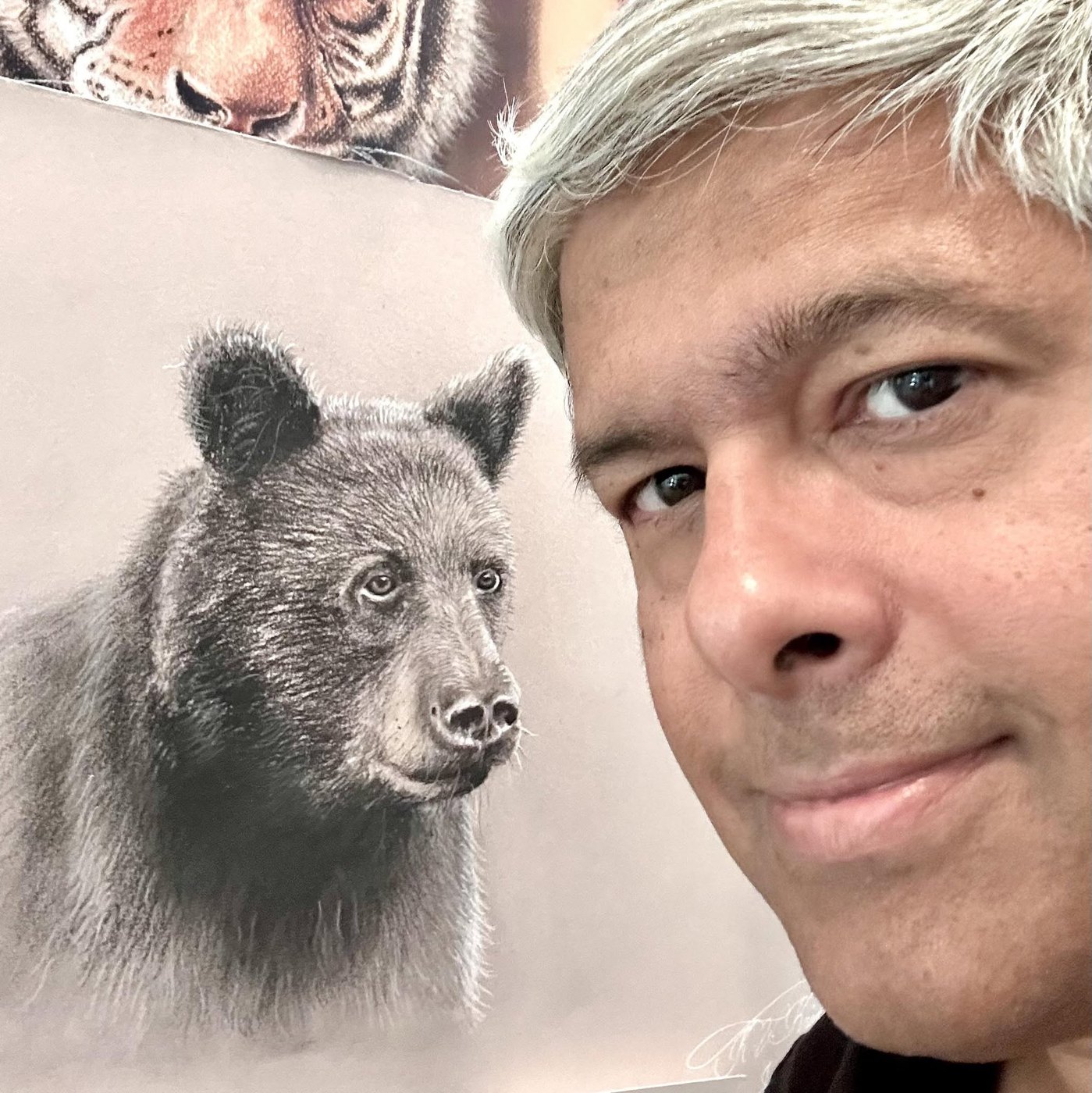 Krish V. Krishnan in his studio with his black bear and tiger artwork